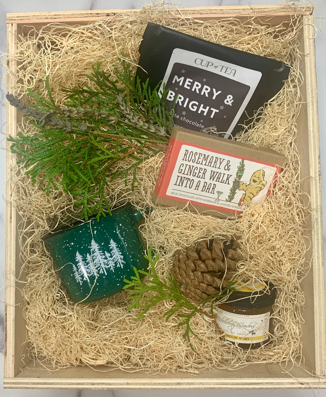 Sample box that includes tea, chocolate,  camping mug and hone