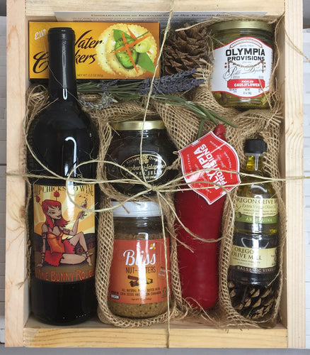 Sample box containing wine, nut butter, olive oil, pickled cauliflower, crackers, sausage and jelly.