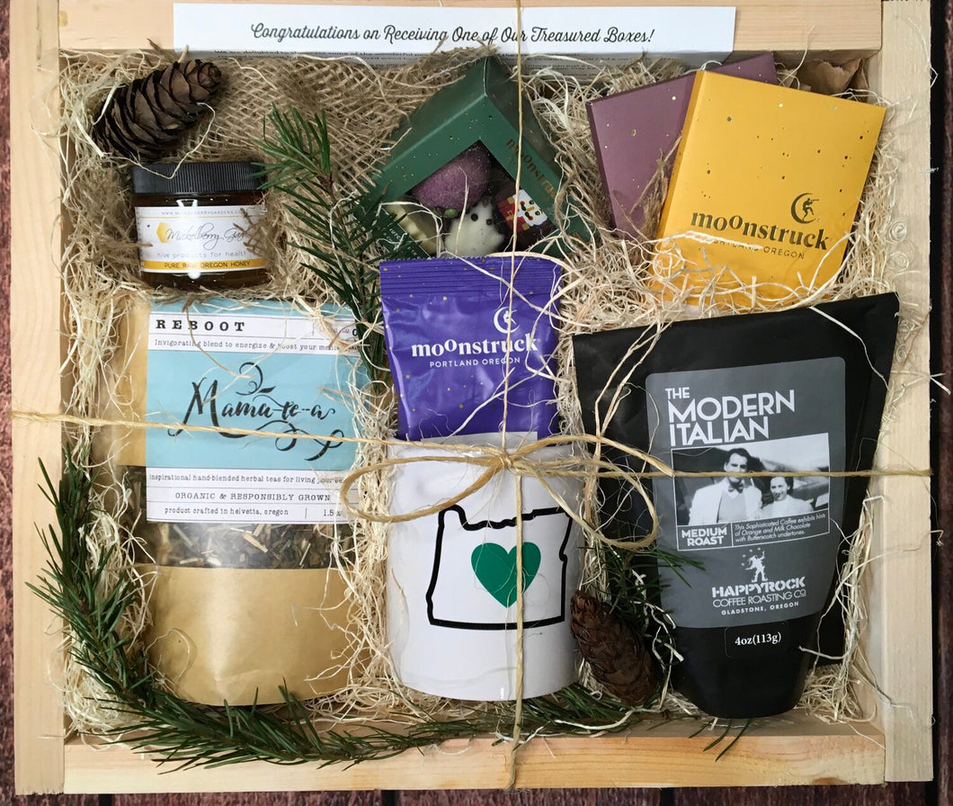 Sample box containing loose leaf tea, chocolate bars, coffee beans, honey, hot chocolate, Oregon Luv mug.