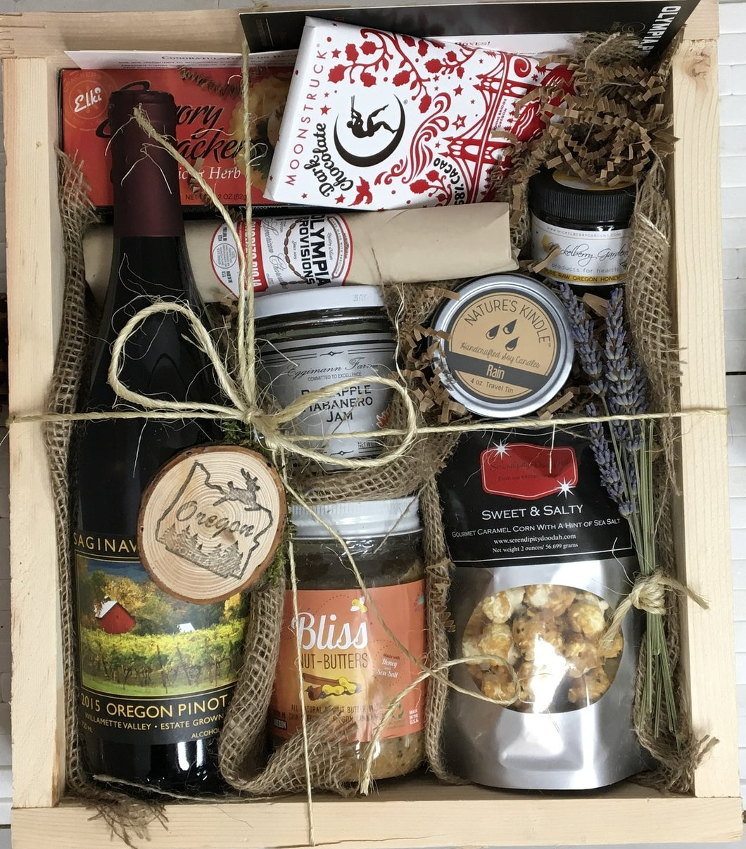 Sample box containing wine, nut butter, jam, honey, crackers, salami, candle, caramel corn, and chocolate bar.